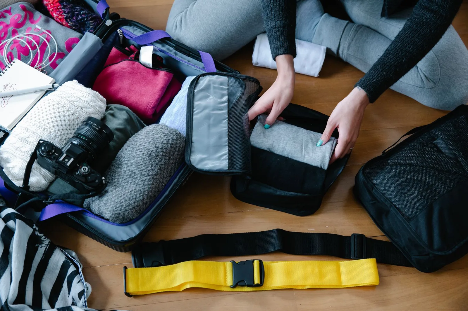 Packing cubes for travel keep clothes compressed and organized in a suitcase
