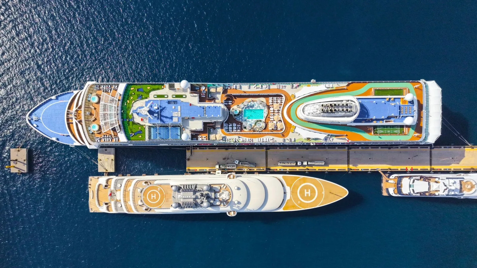 Large cruise ship at sea with multiple pools and water slides