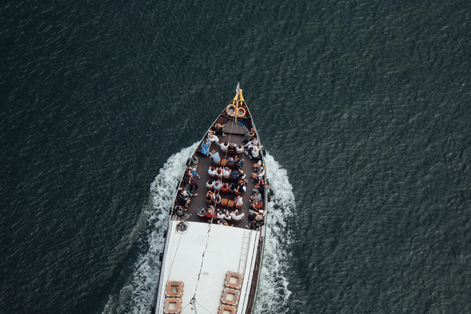 Woman looking out over a cruise ship deck at the ocean