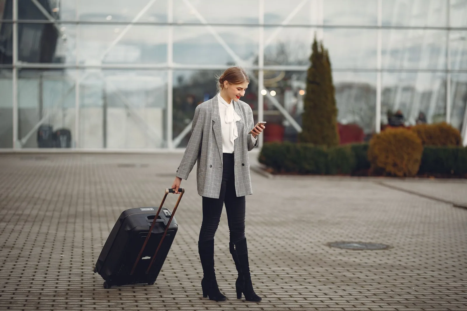 A business traveler's carry-on packed with a folded suit and laptop