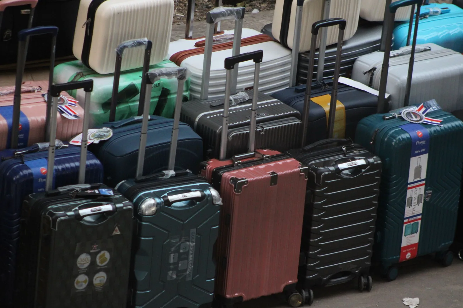 A hard-shell carry-on suitcase rolling through an airport terminal